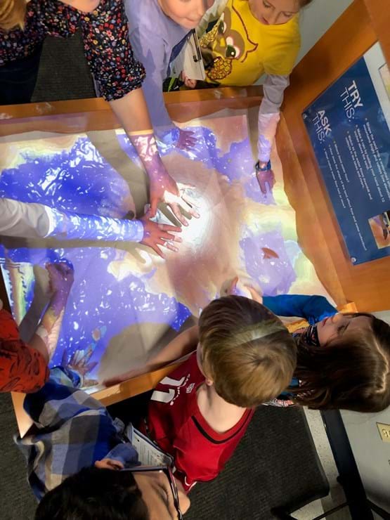 children using the sandbox exhibit